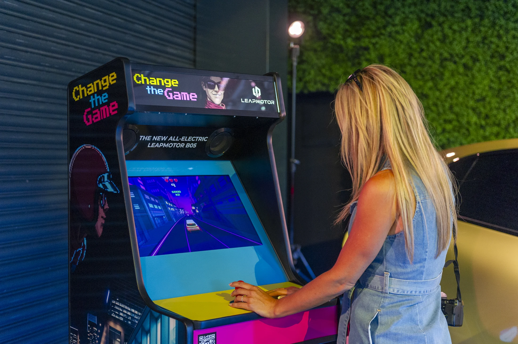 Guest playing the bespoke Leapmotor Change the Game cabinet at the launch event
