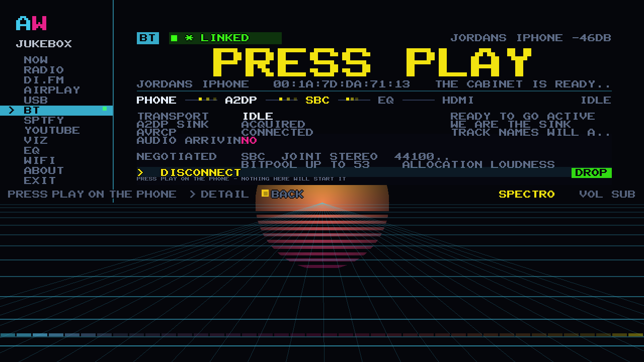 A phone linked to the cabinet over Bluetooth: the LINKED chip, PRESS PLAY across the screen and the phone's name underneath