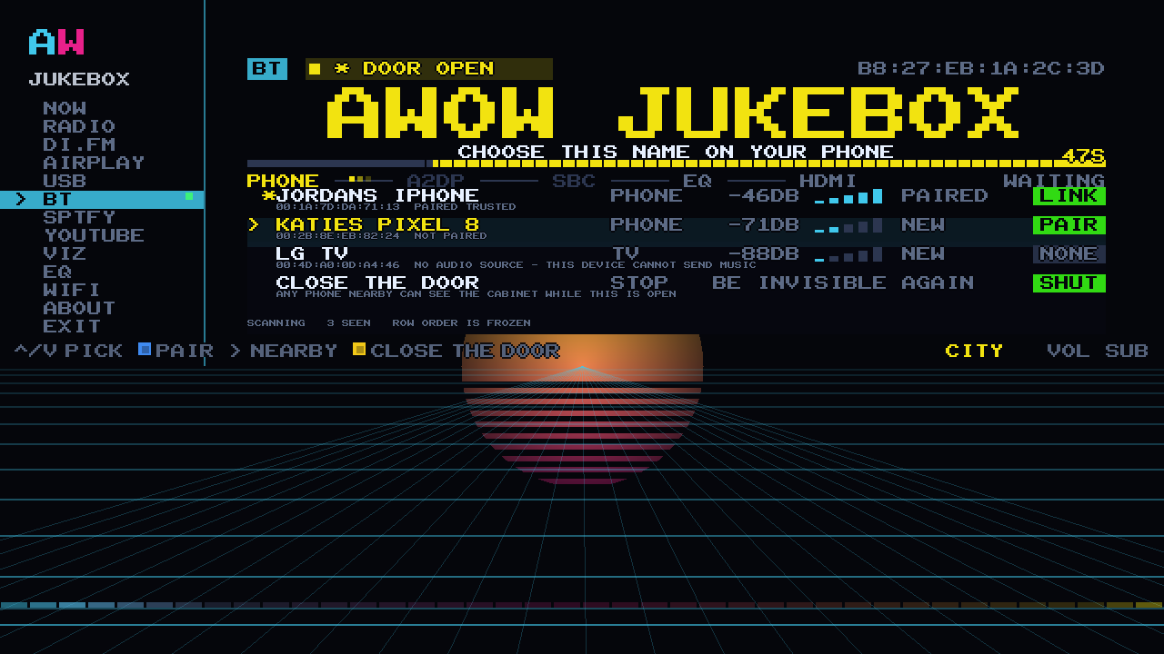 The Bluetooth pairing door open on the cabinet: AWOW JUKEBOX in huge pixel type, CHOOSE THIS NAME ON YOUR PHONE, and a 60 second fuse counting down