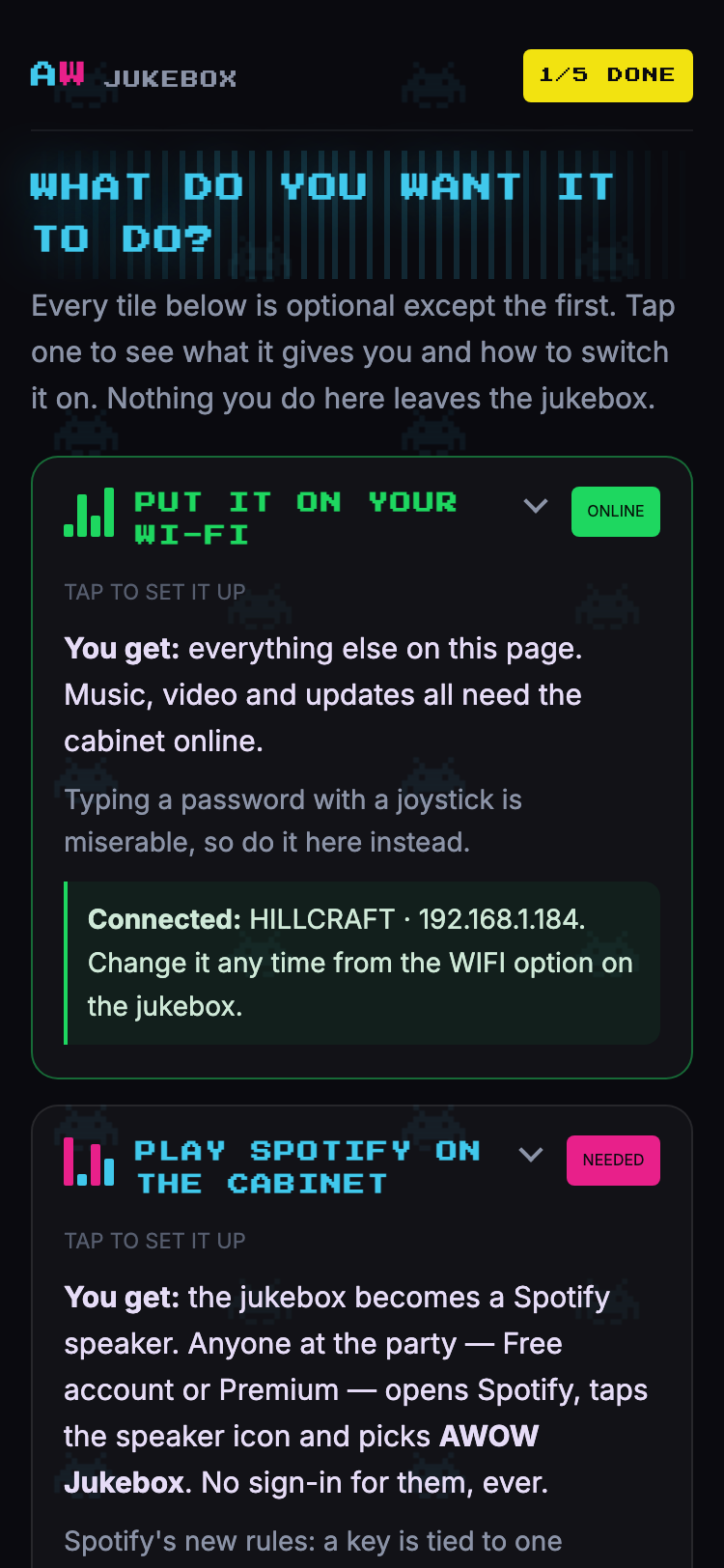 The cabinet's setup page on a phone: AW JUKEBOX, 1/5 DONE, WHAT DO YOU WANT IT TO DO, and the tiles for Wi-Fi, Spotify and YouTube